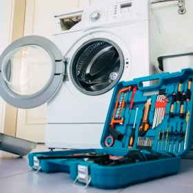 a laundry room with tools and a washer and dryer.